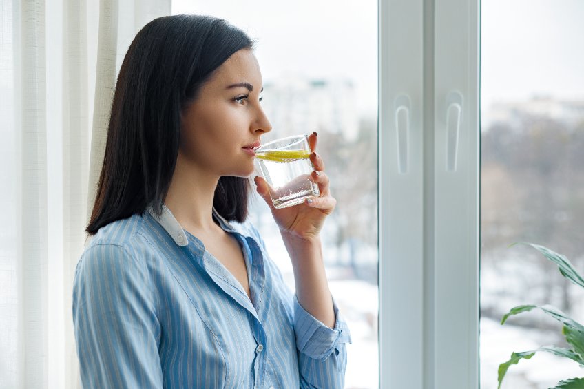 a woman drinking lemon water with MiraBurst