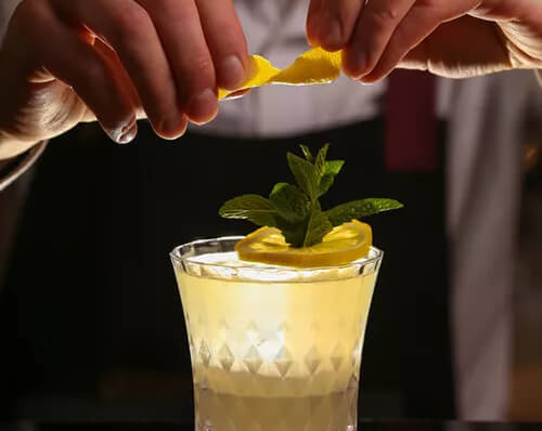 a person making a lemon cocktail with Miracle Berries
