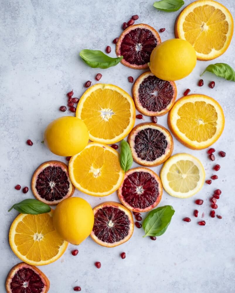 blood oranges and lemons sliced on a countertop