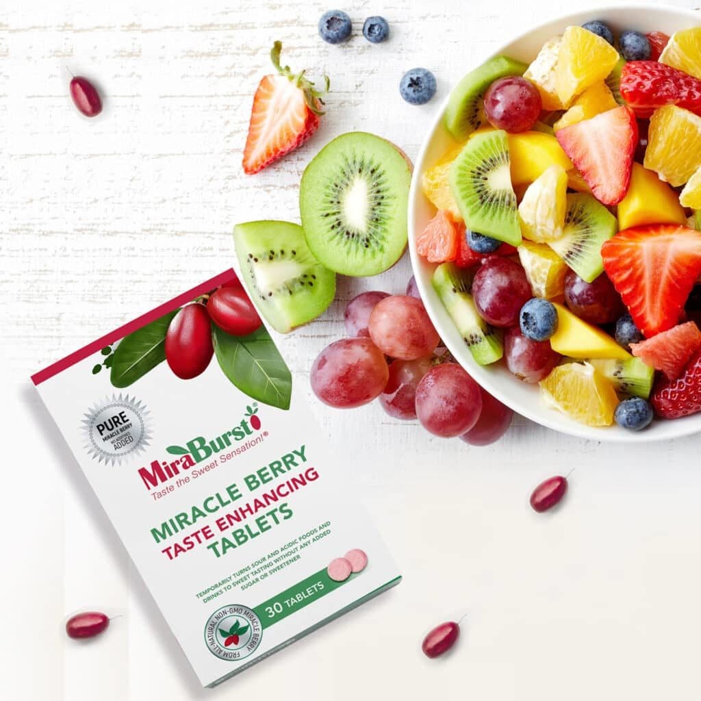 MiraBurst miracle berry products next to a fruit salad bowl
