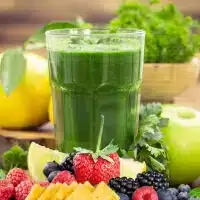 green smoothie glass near berries