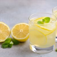 lemon water near lemon slices