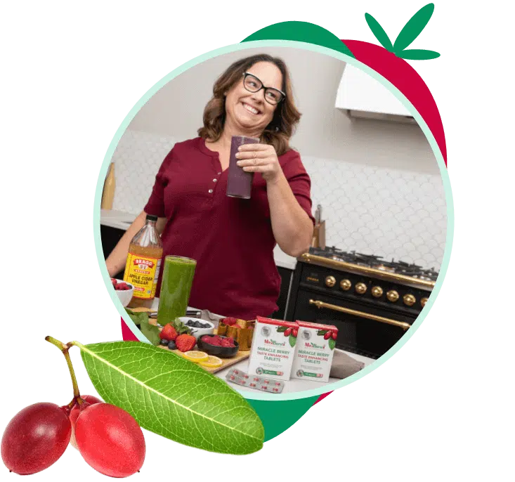 A woman drinking a MiraBurst Miracle Berry smoothie in the kitchen